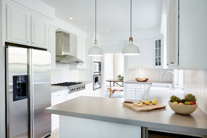 Modern kitchen with layered ambient recessed light, under cabinet task lights and accent lighting